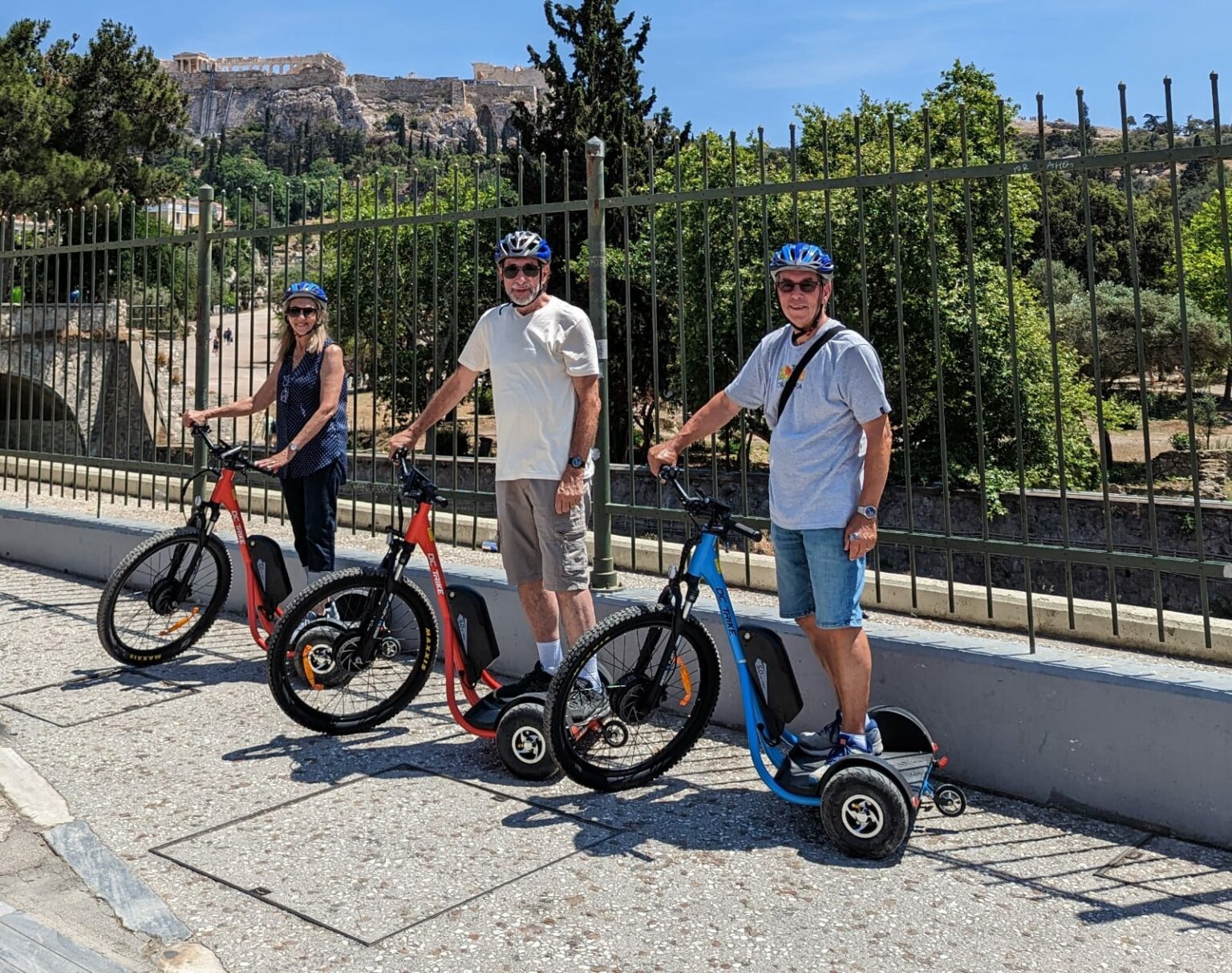 Tourists on Ayo e-trikes with the Acropolis behind them